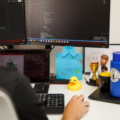 a person is sitting at a desk in front of a computer .