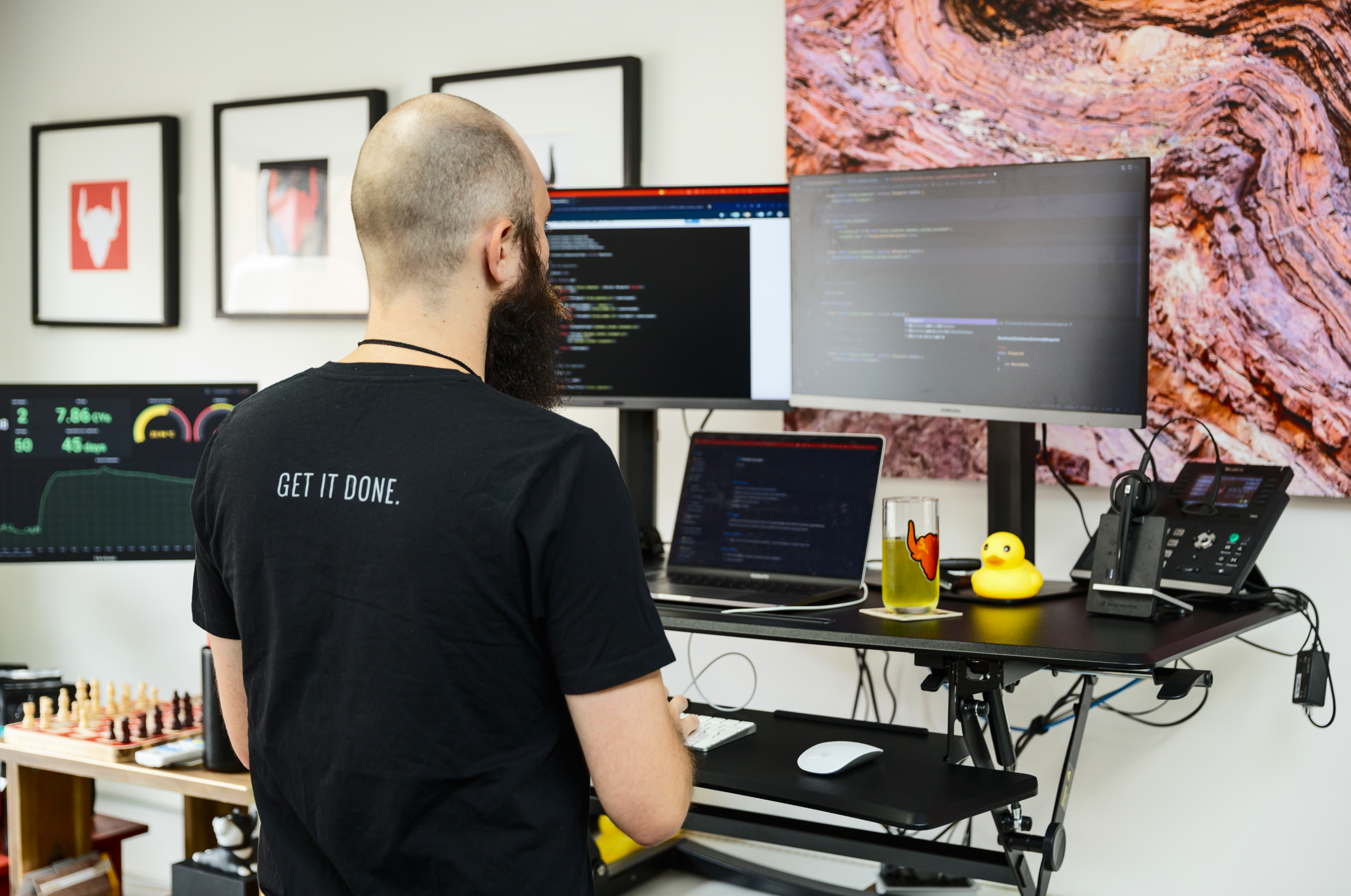 a man wearing a black shirt that says get it done